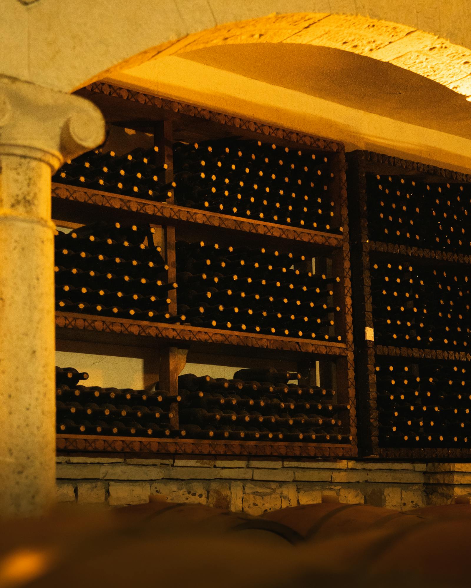 An old French oak barrel marked with a chalk vintage stamp 2023 in the dim cellar.