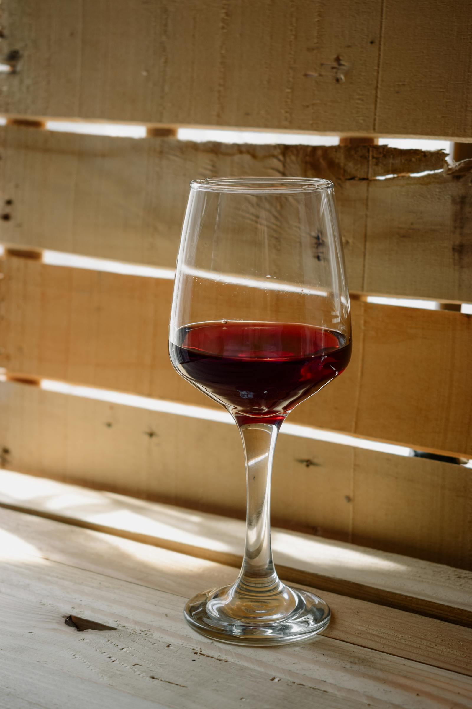 Vermora Cabernet Franc — a single glass on the slate counter of the tasting room.